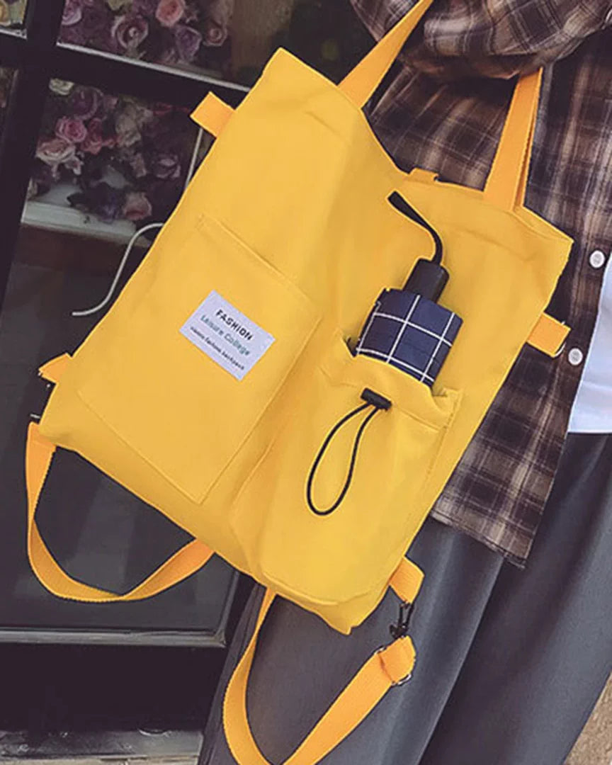 The convertible canvas tote in marigold yellow, front view
