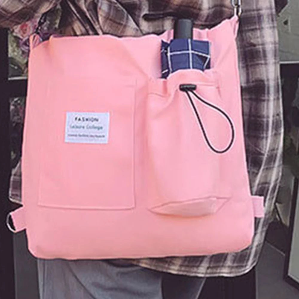 The tote worn crossbody in Pink, long strap at full length