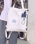 White convertible canvas tote, front view, on a pale field