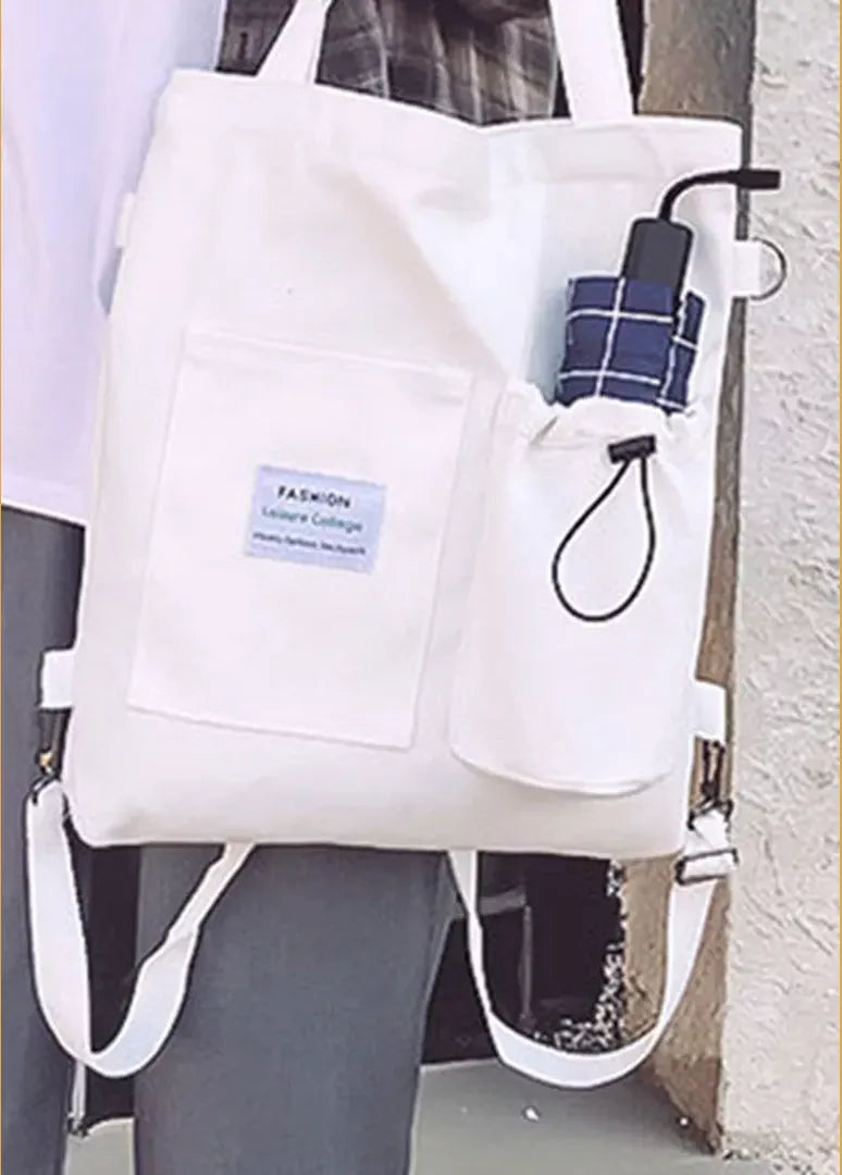 The white convertible canvas tote worn on one shoulder