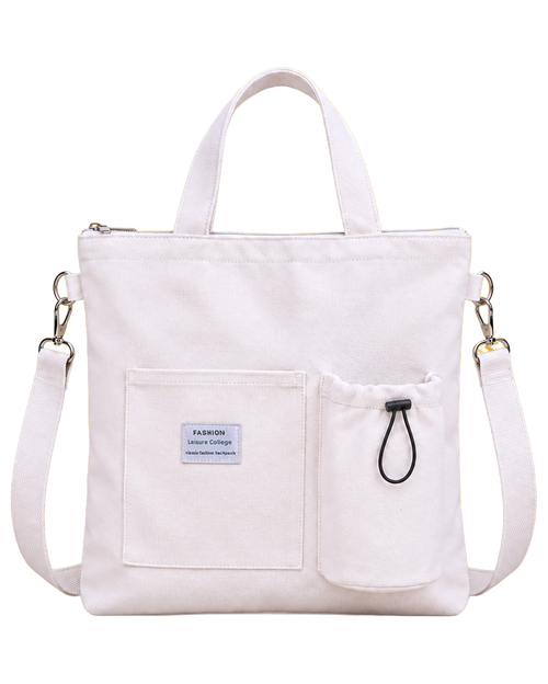 The Totebee convertible canvas tote in white, front view, showing the two short top handles, the flat front pocket with a small woven label carrying the manufacturer's decorative type, and the drawstring bottle pocket
